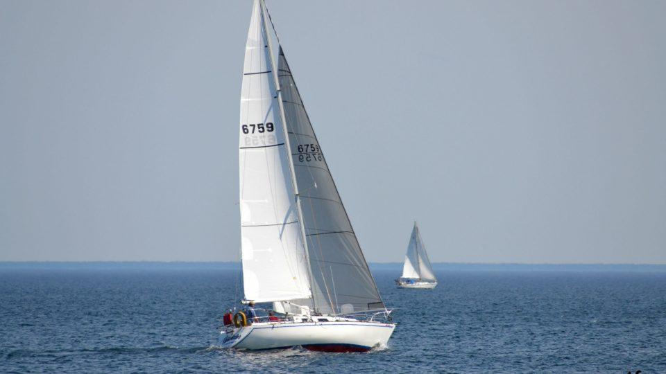 two white sail boats