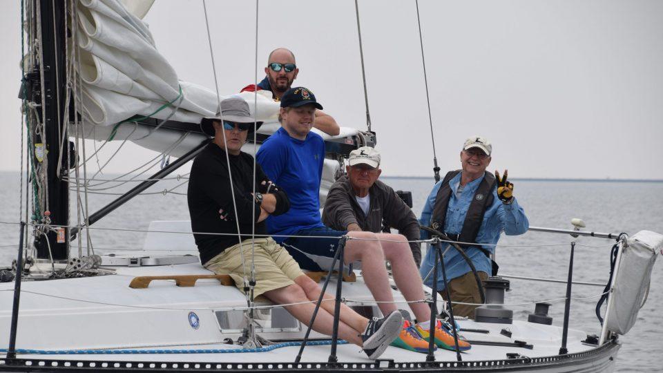 M&M Yacht Club members together on a sailboat